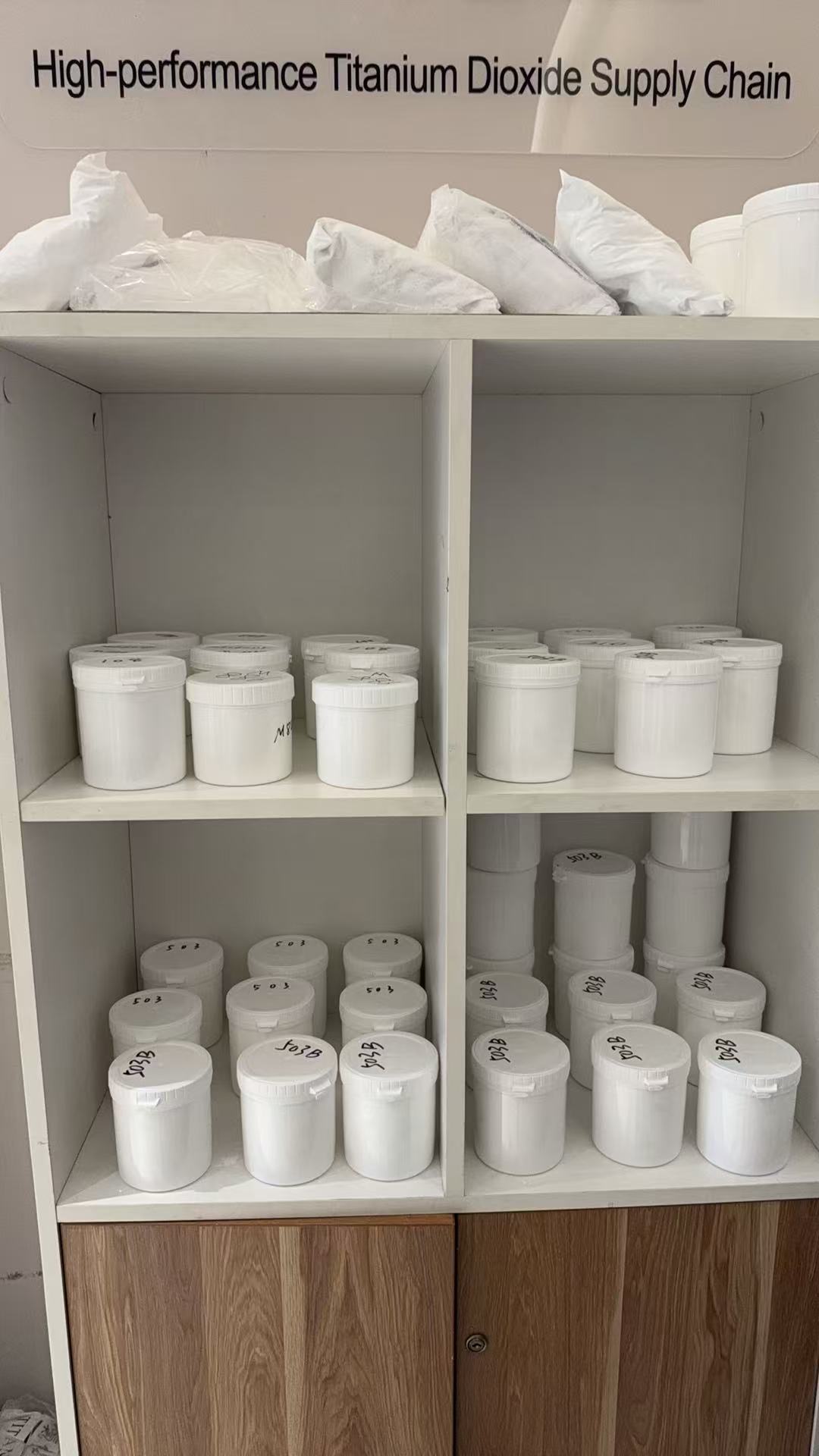 Sample containers displayed on white shelves